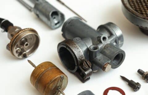 Gearbox taken apart and laid out on a white background.